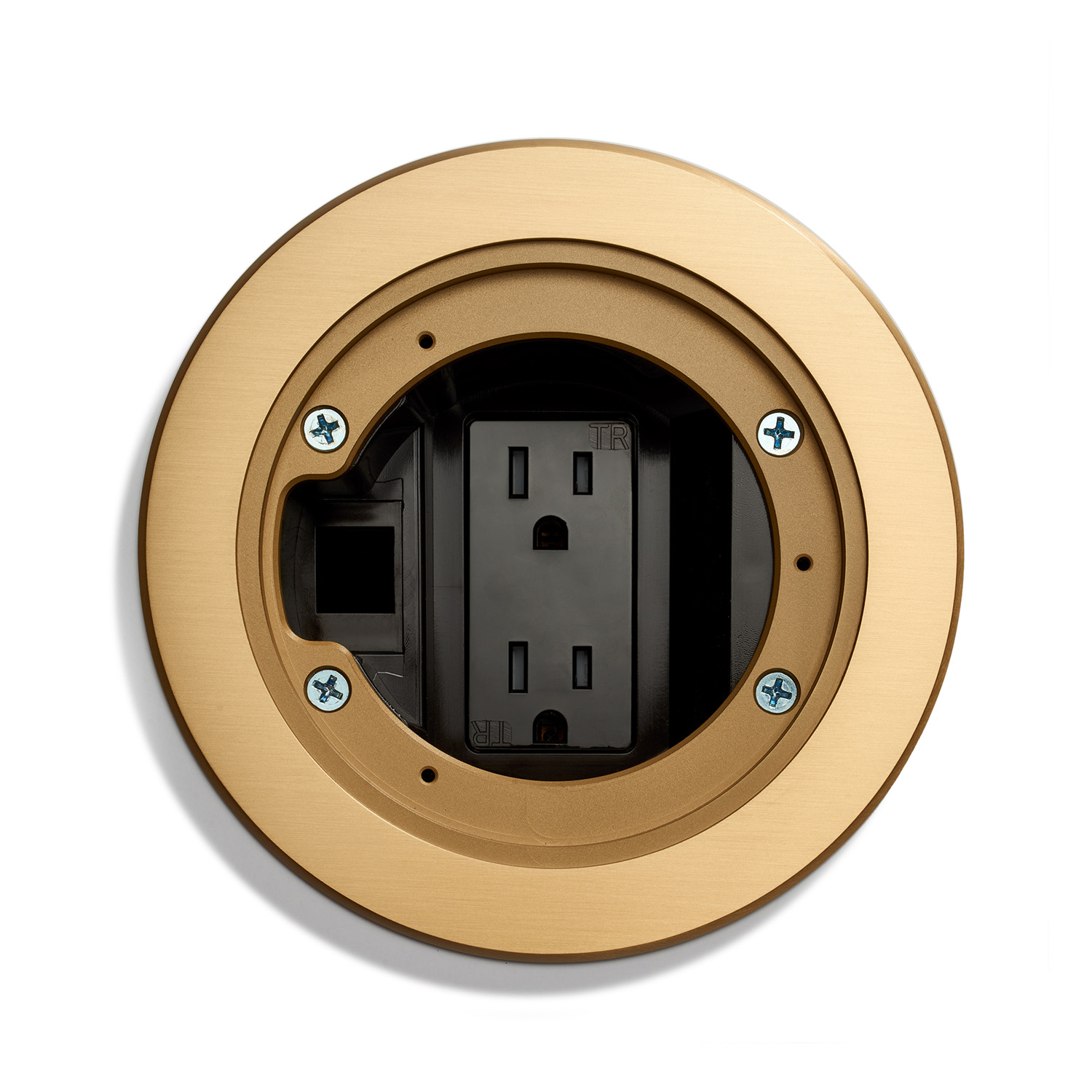 A round, gold recessed floor outlet box cover open to reveal electrical sockets mounted on a white background.