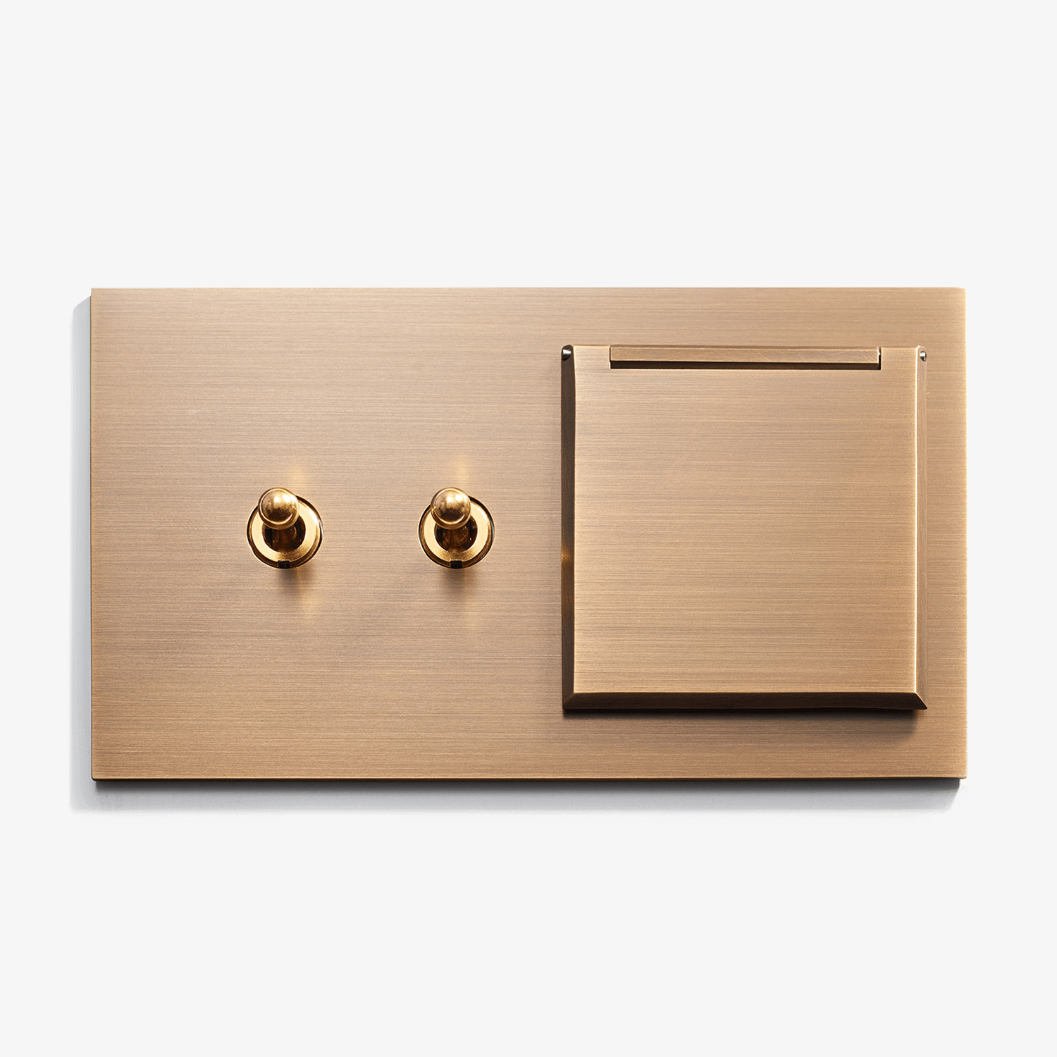 A sleek, modern brushed gold wall plate featuring two circular knobs and a rectangular switch, isolated on a white background.