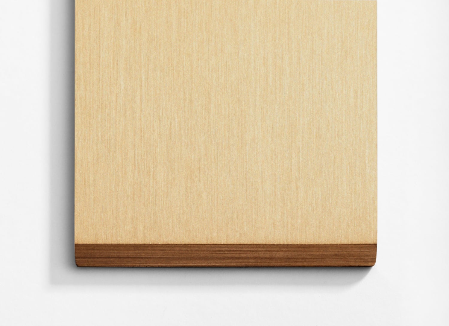 A wooden cutting board on a white wall.