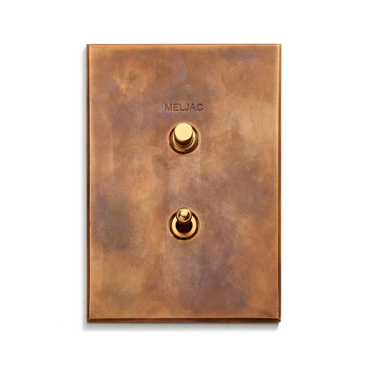 A rectangular, bronze-colored light switch plate with two gold toggle switches arranged vertically. The word "MELJAC" is inscribed above the top switch.