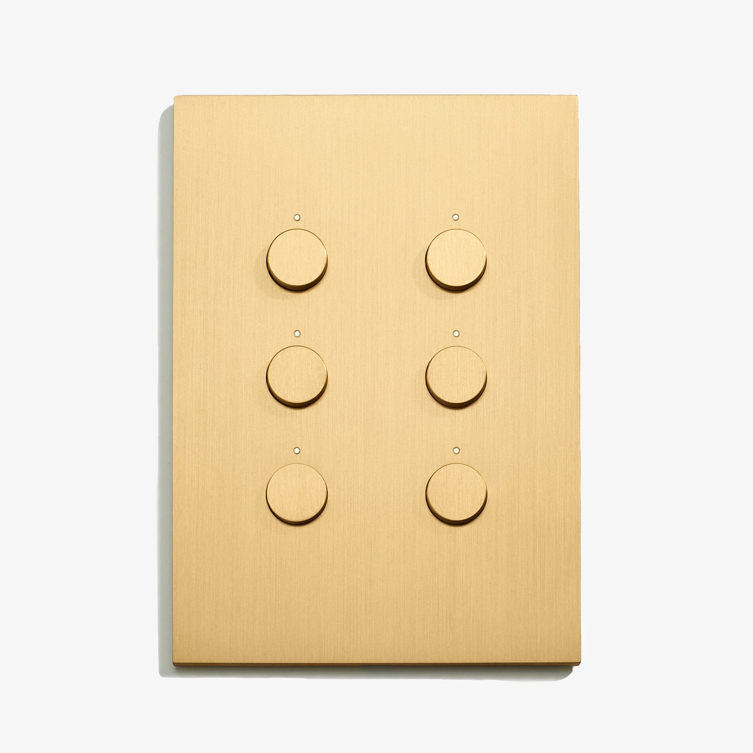 A light switch with four buttons on a white surface.