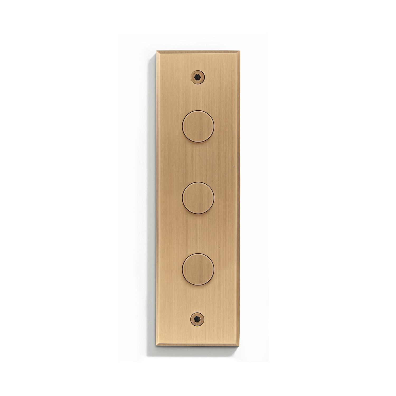 A brass wall plate with four buttons on it.