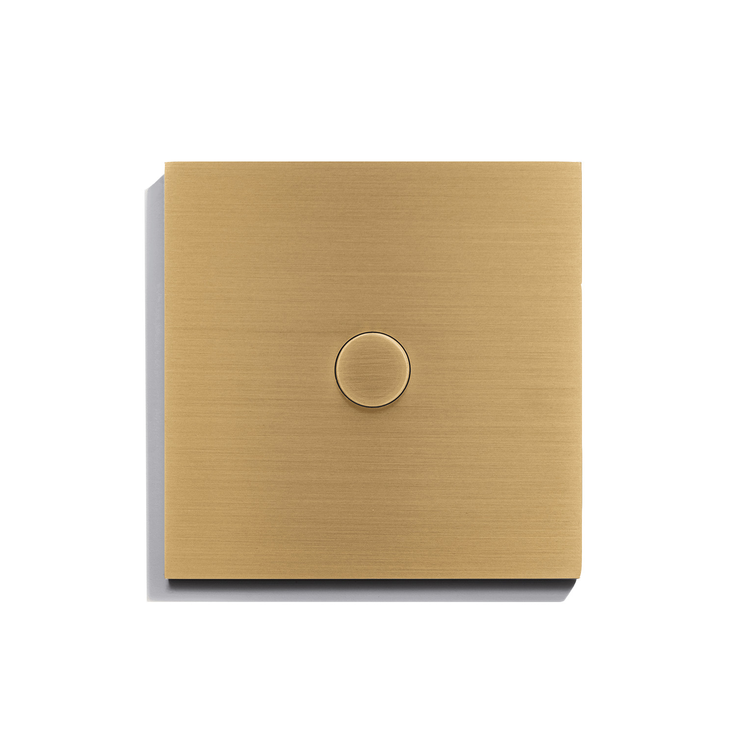 A gold light switch on a white surface.