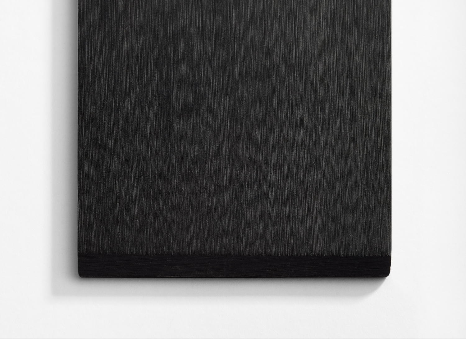 A black painting on a white wall.