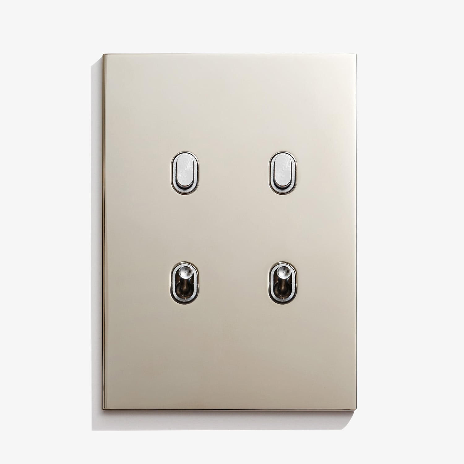 Three light switches on a white surface.