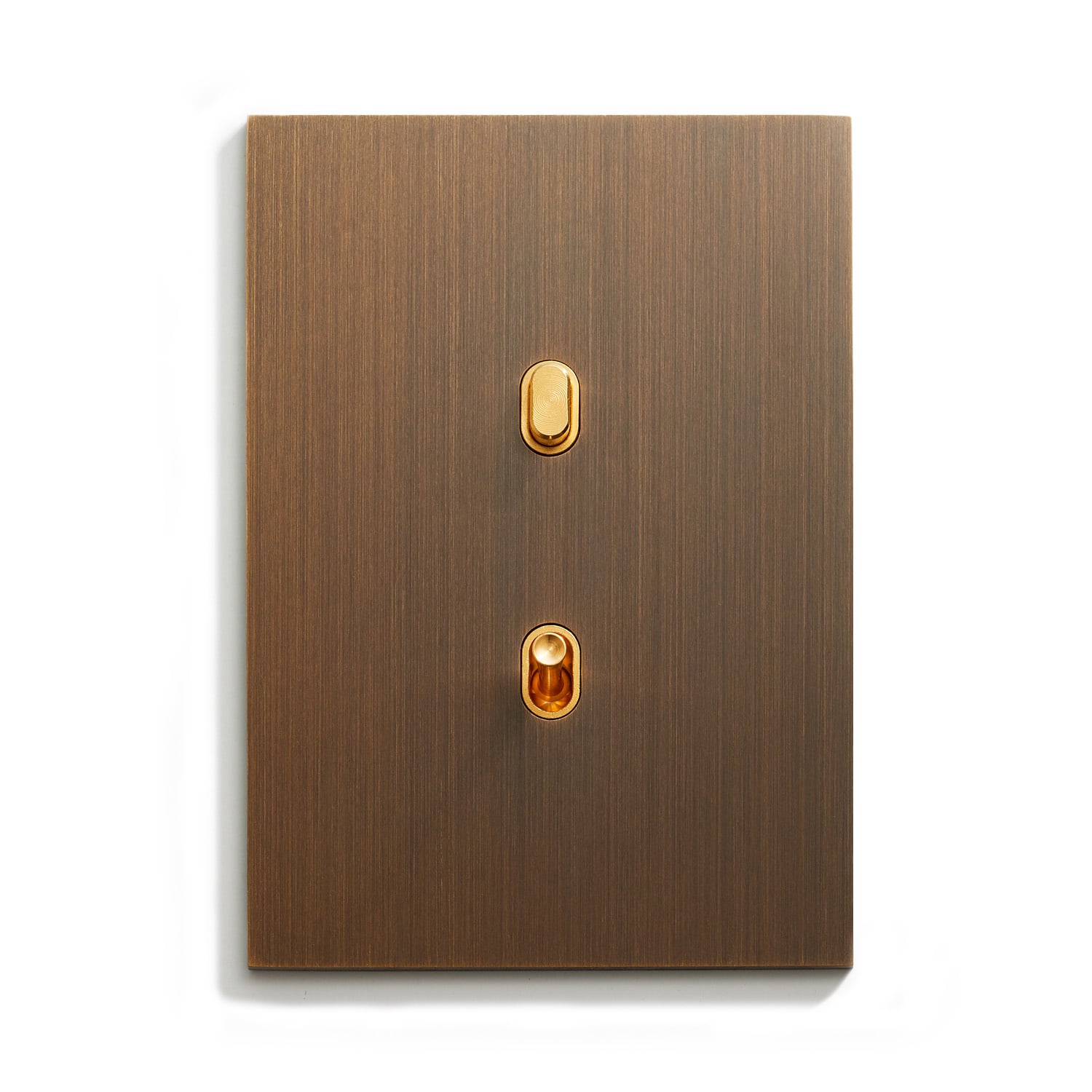 A light switch with a brown metal plate on it.