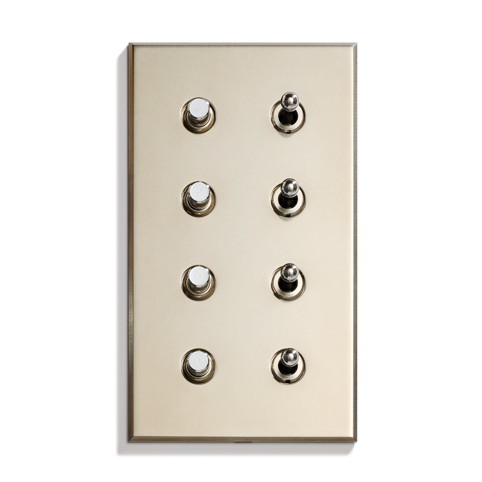 A metallic light switch panel with eight round toggle switches arranged in two columns and four rows, mounted on a beige wall.
