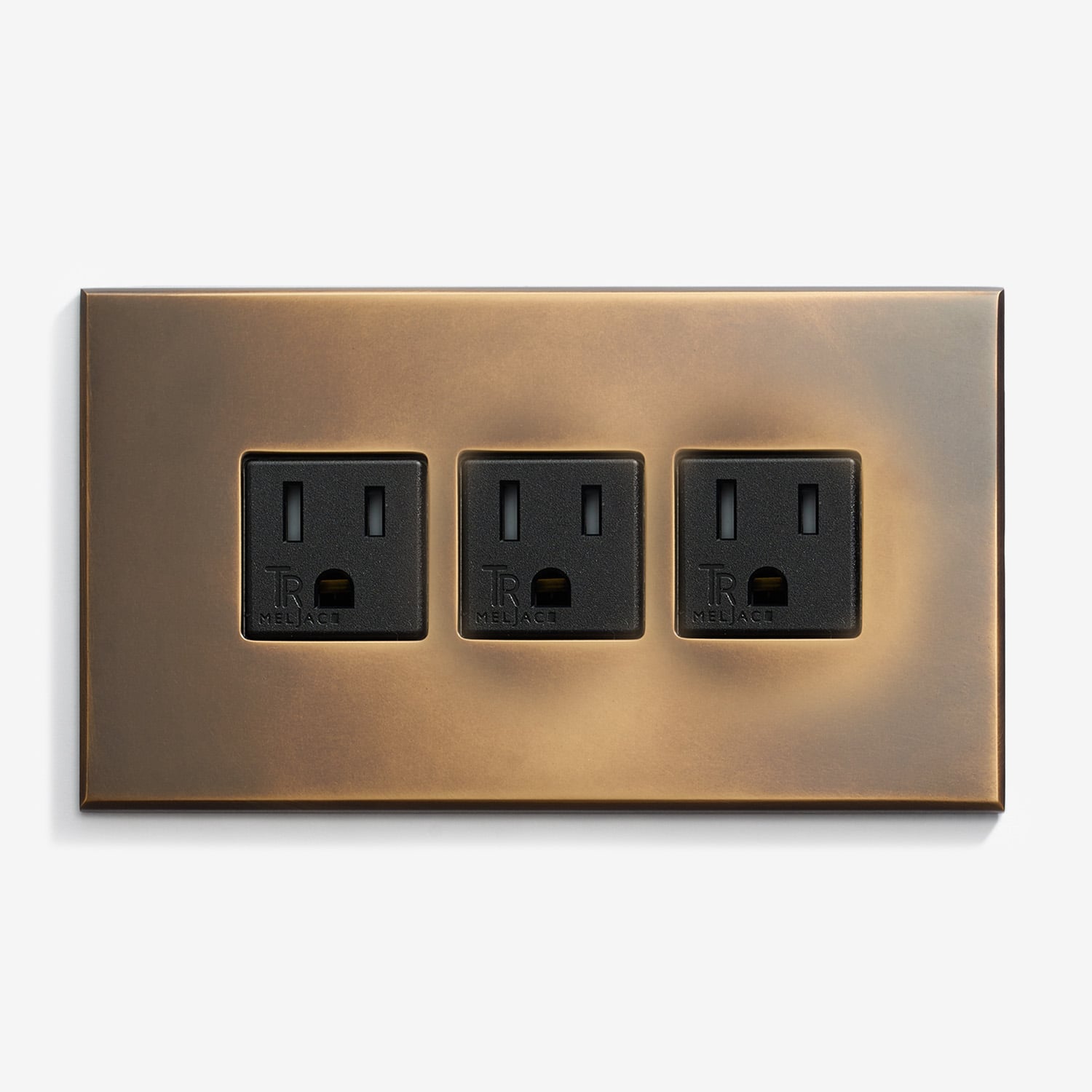 A wall plate with three outlets on it.