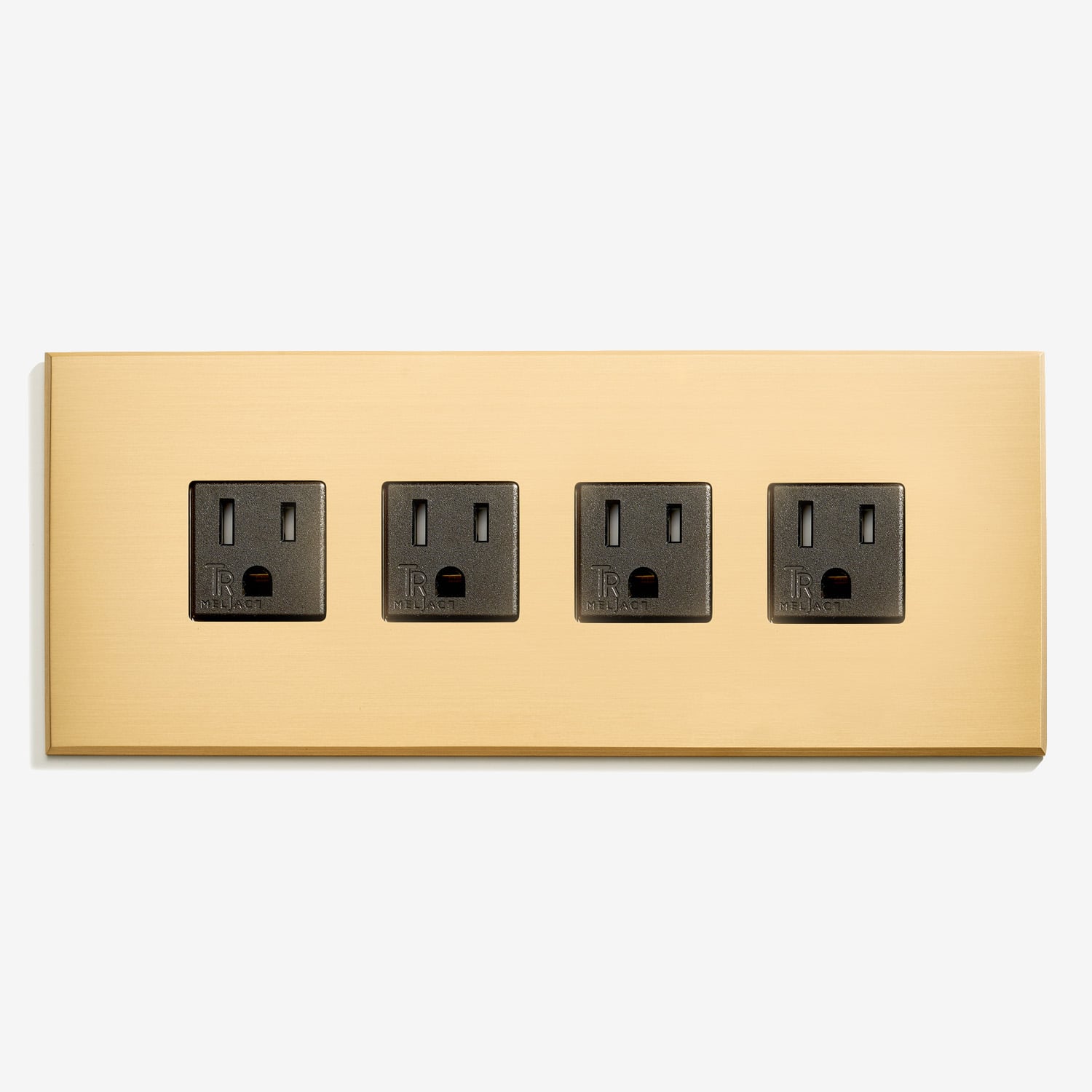 A gold wall plate with four outlets on it.