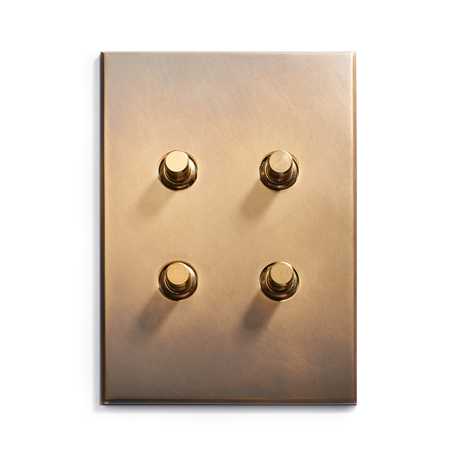 A brass light switch with four buttons on it.