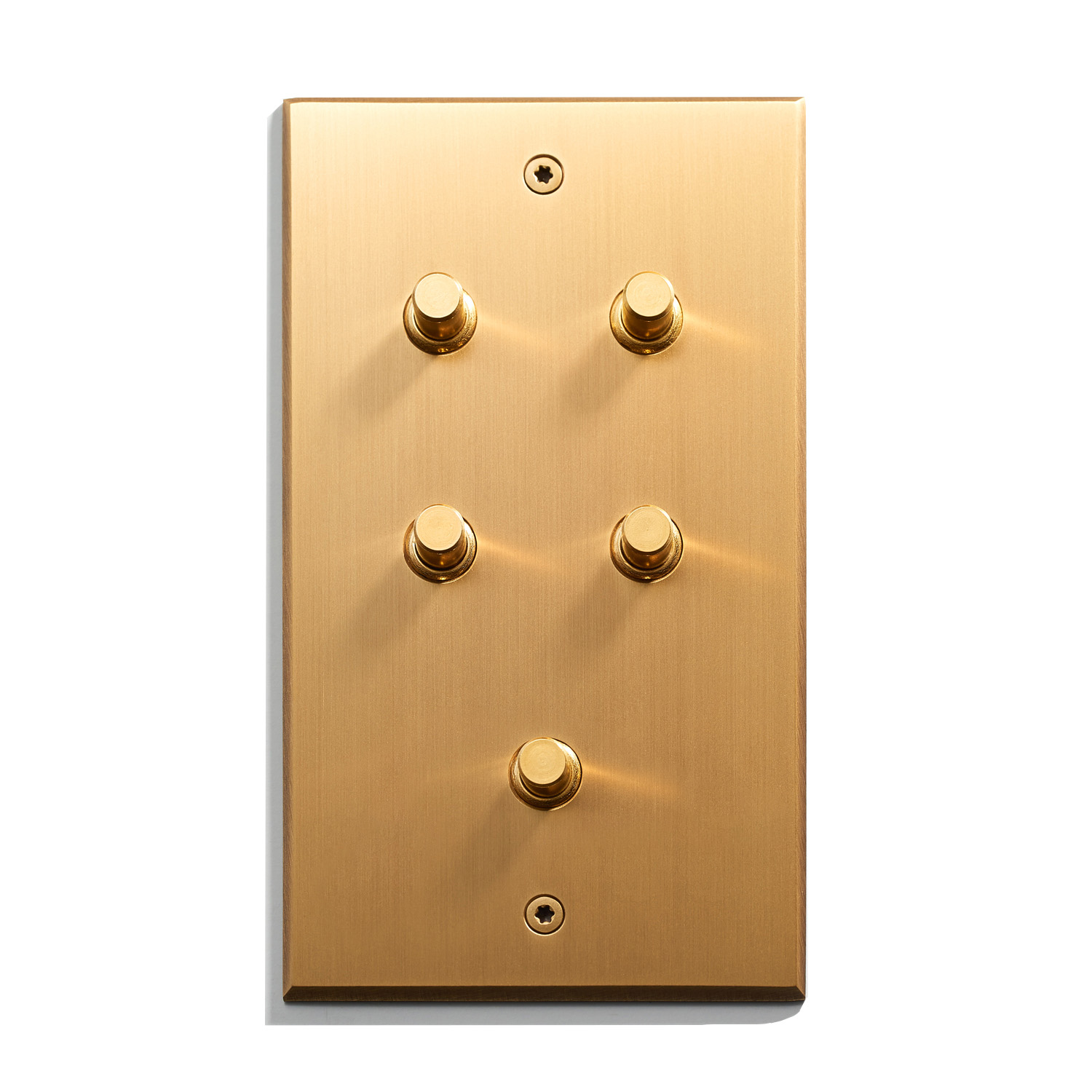 A gold plate with four buttons on it.