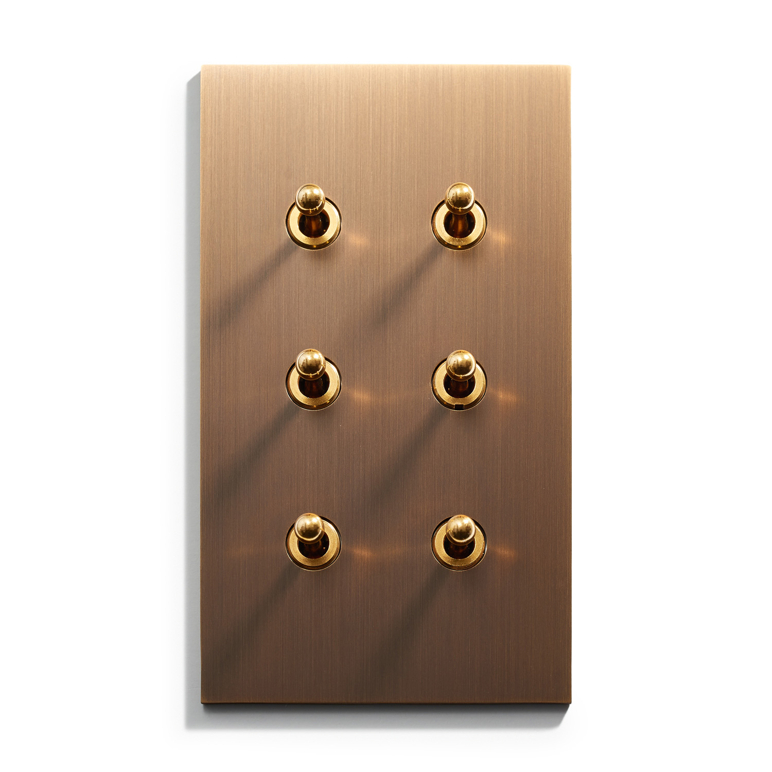 A wall plate with four gold buttons on it.