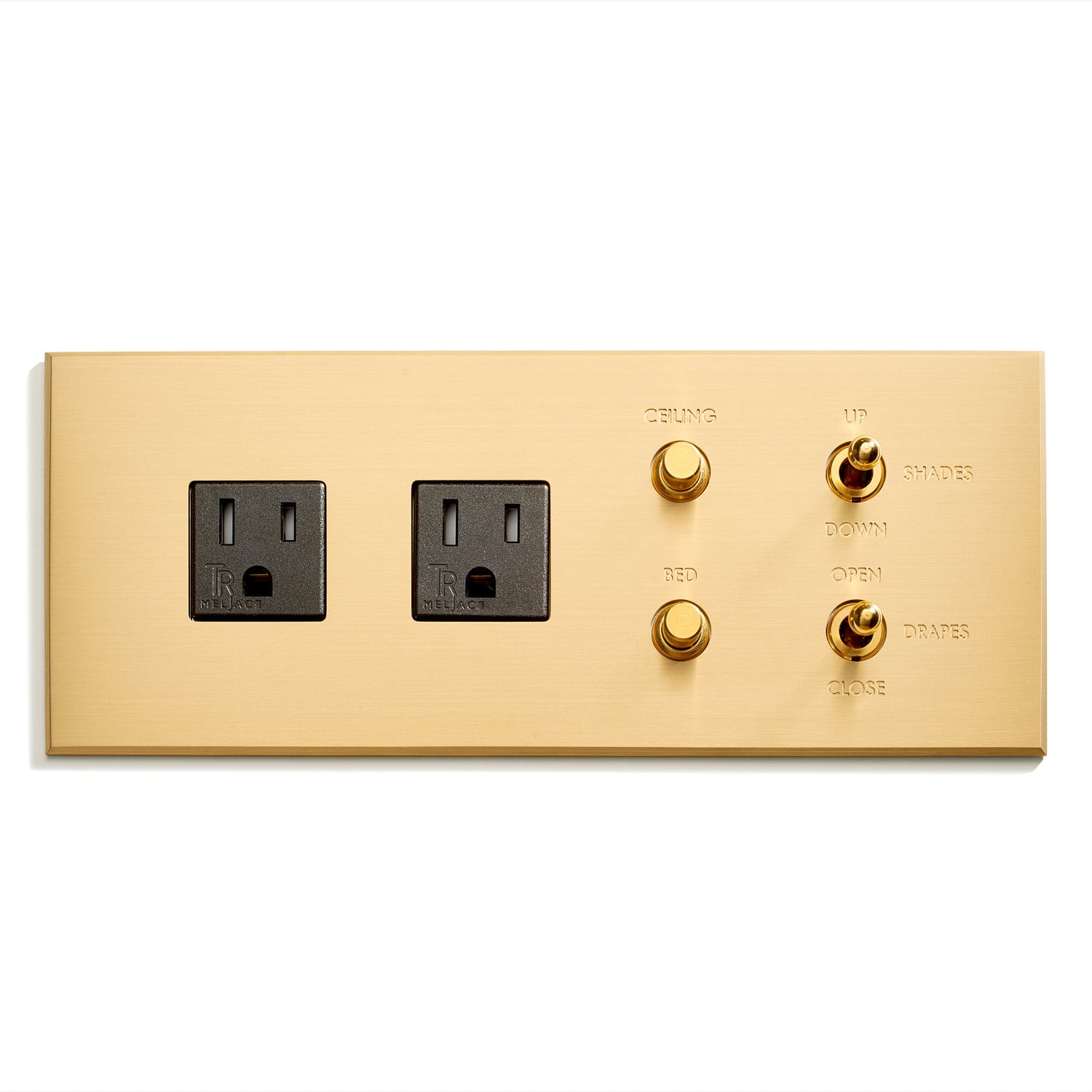 A gold wall plate with two outlets on it.