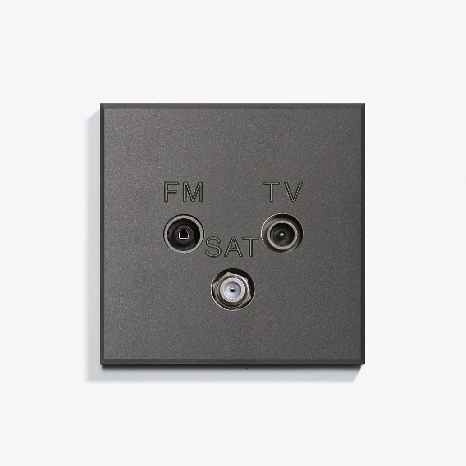 A black tv socket on a white surface.