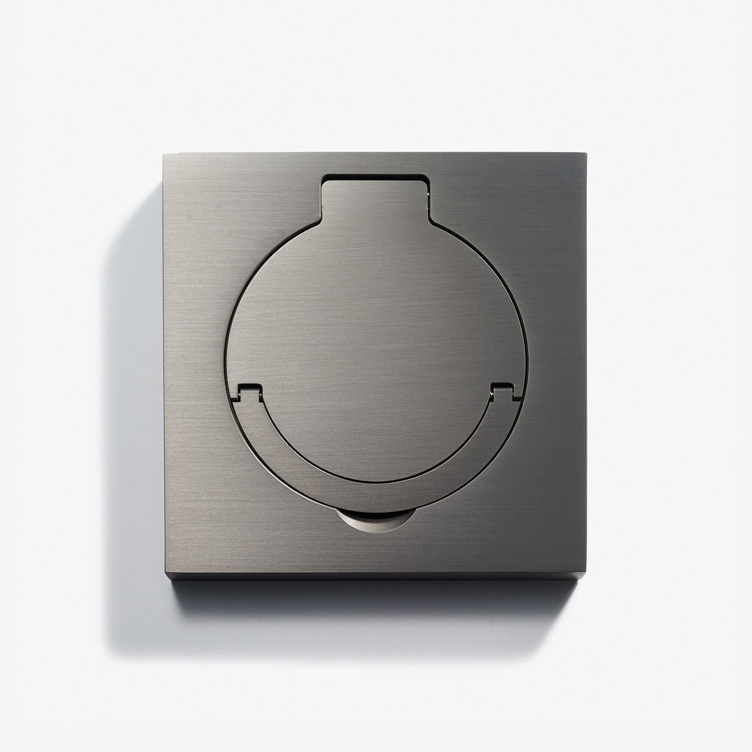 A sleek stainless steel wall plate with a circular cutout, possibly for an electrical outlet or switch, presenting a modern and minimalist design on a white background.
