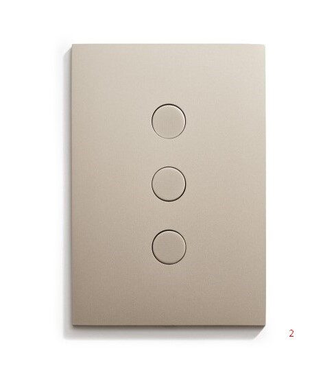 A light switch with three buttons on a white surface.