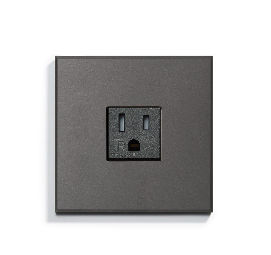 A black electrical outlet on a white surface.