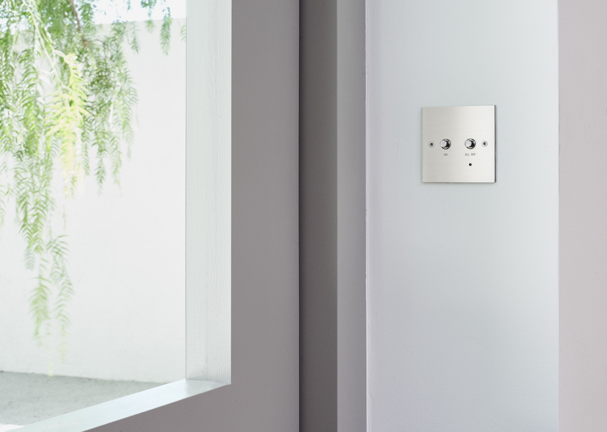 A light switch on a wall in a room.