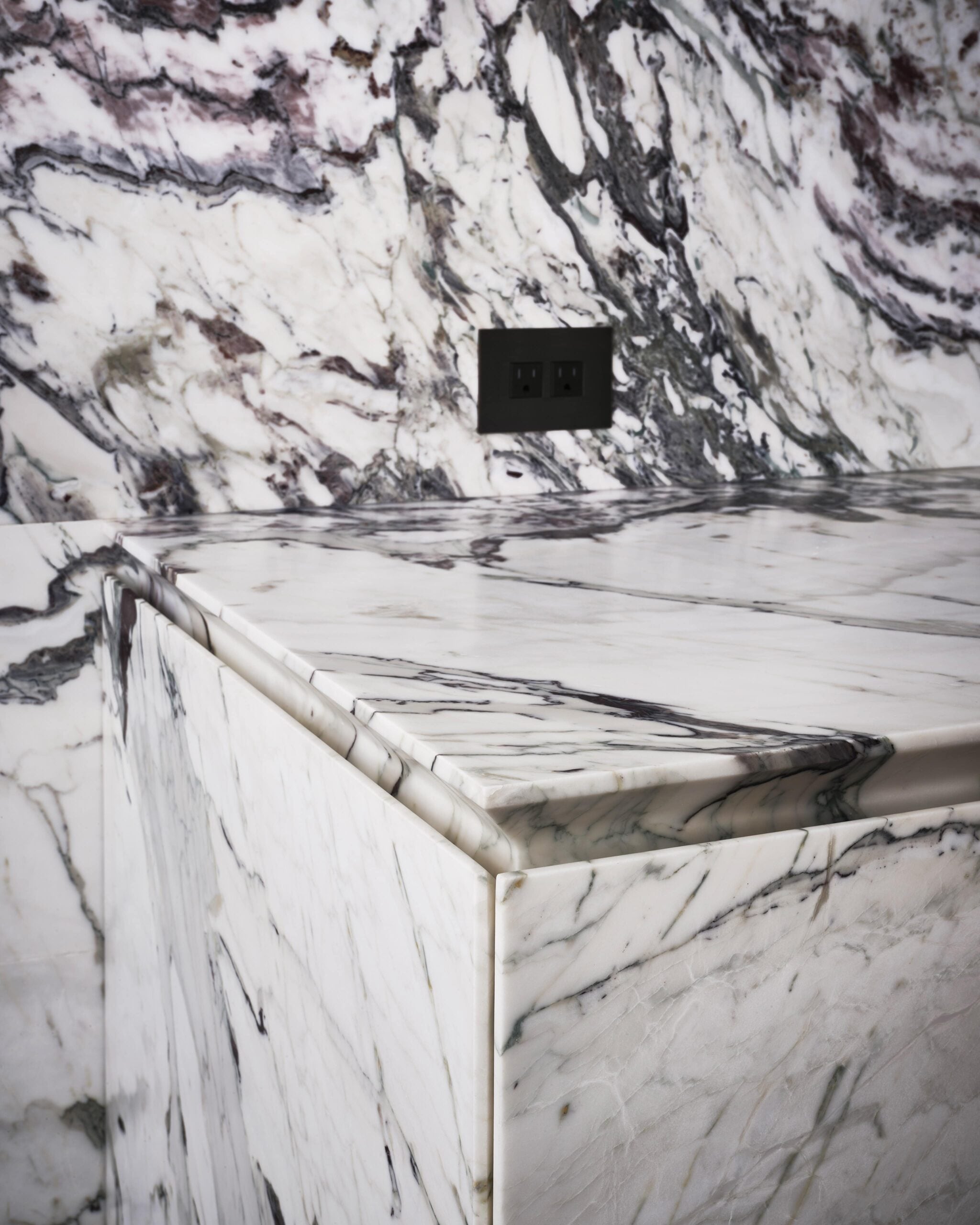 A bathroom with a marble counter top.
