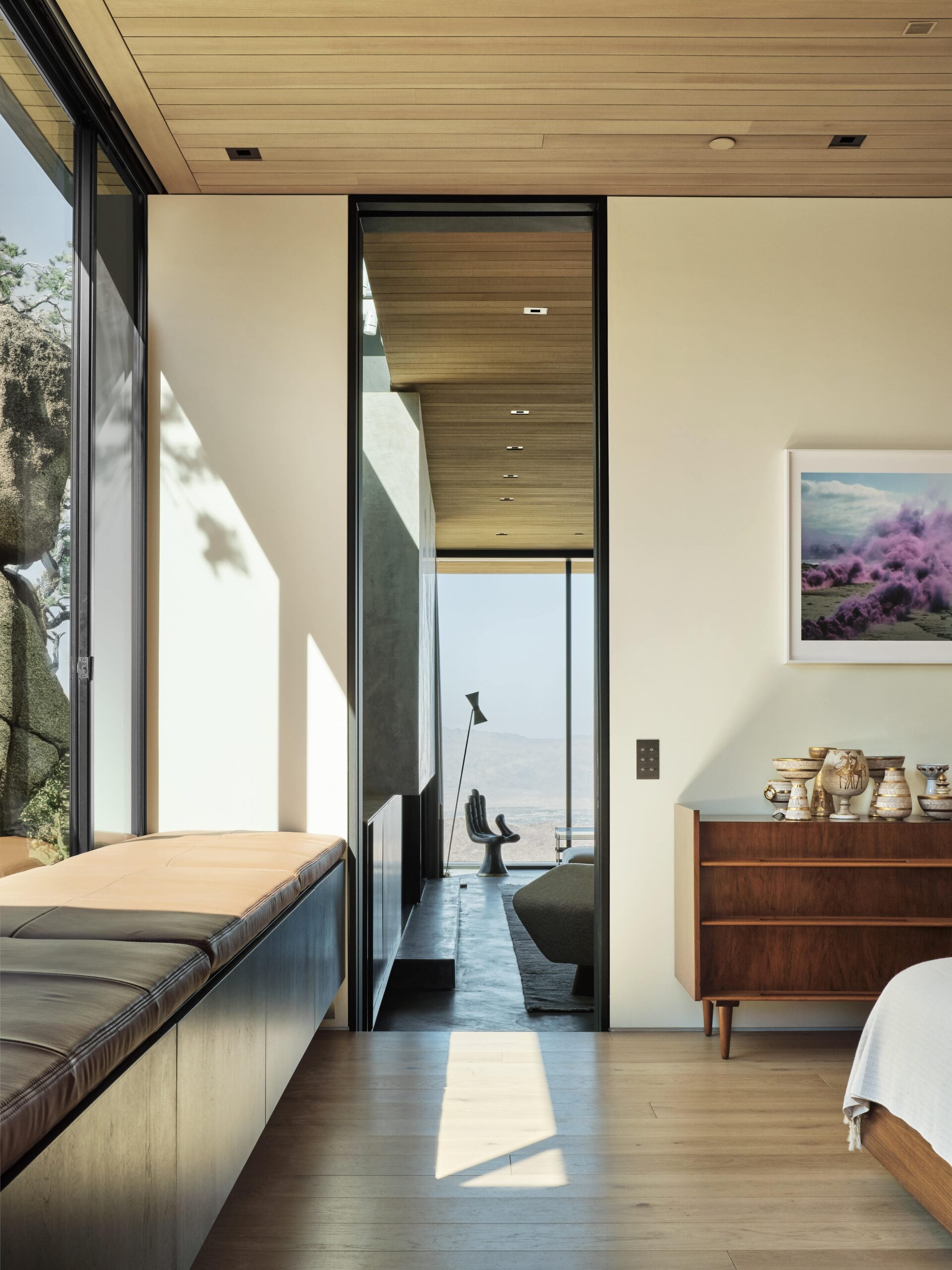 A modern bedroom with a view of the mountains.
