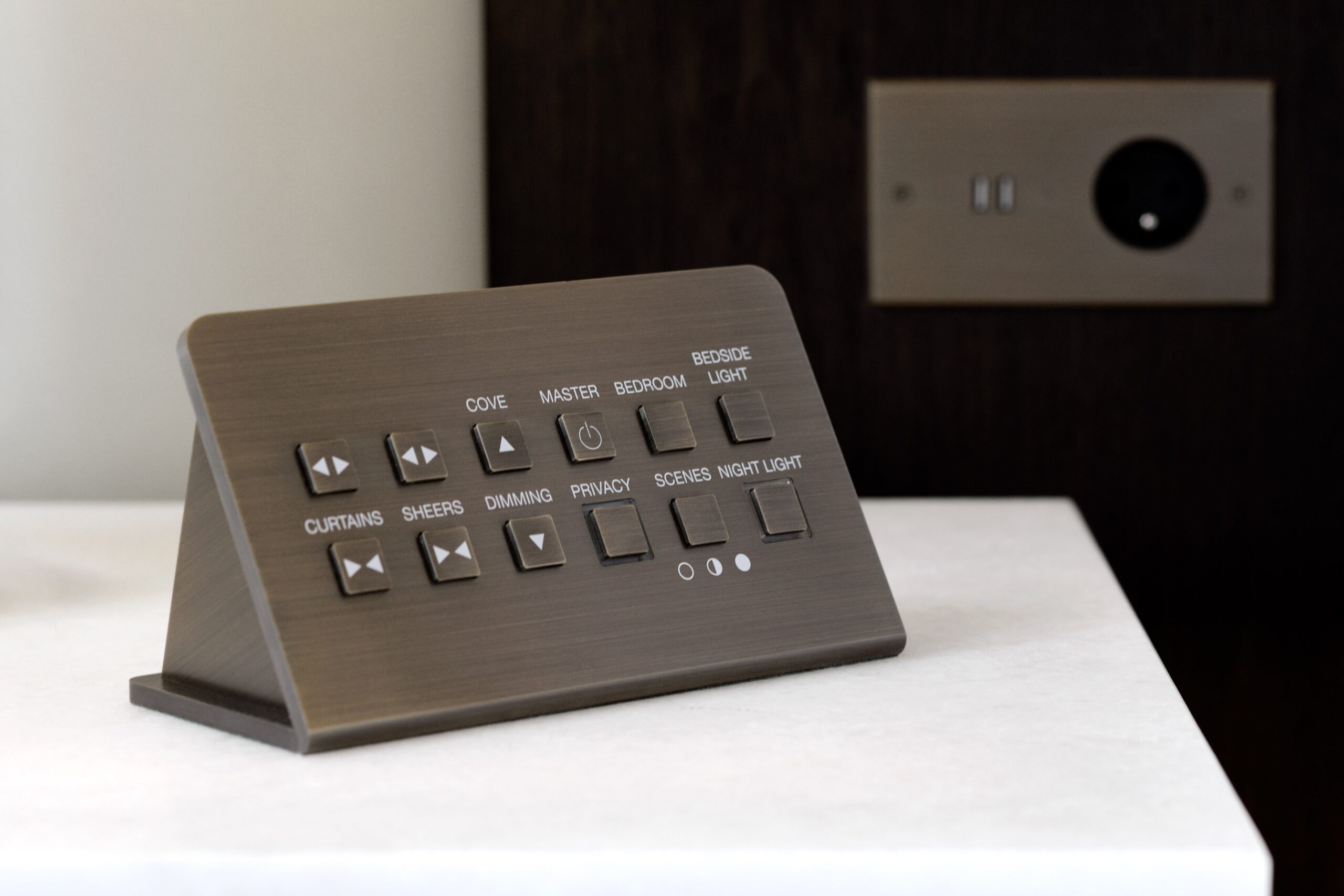 A brown remote control is sitting on a table.