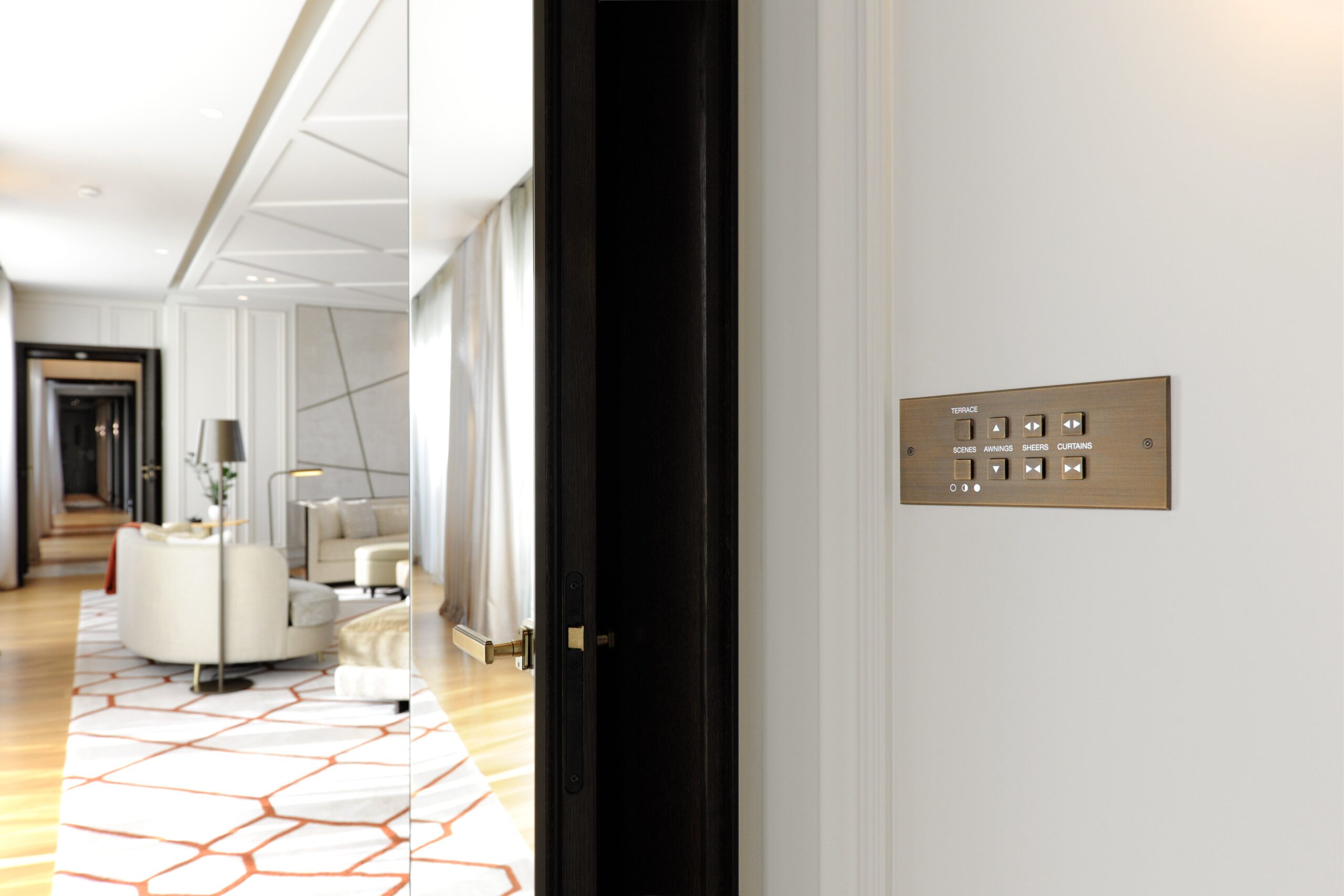 A hallway with a door and a mirror.