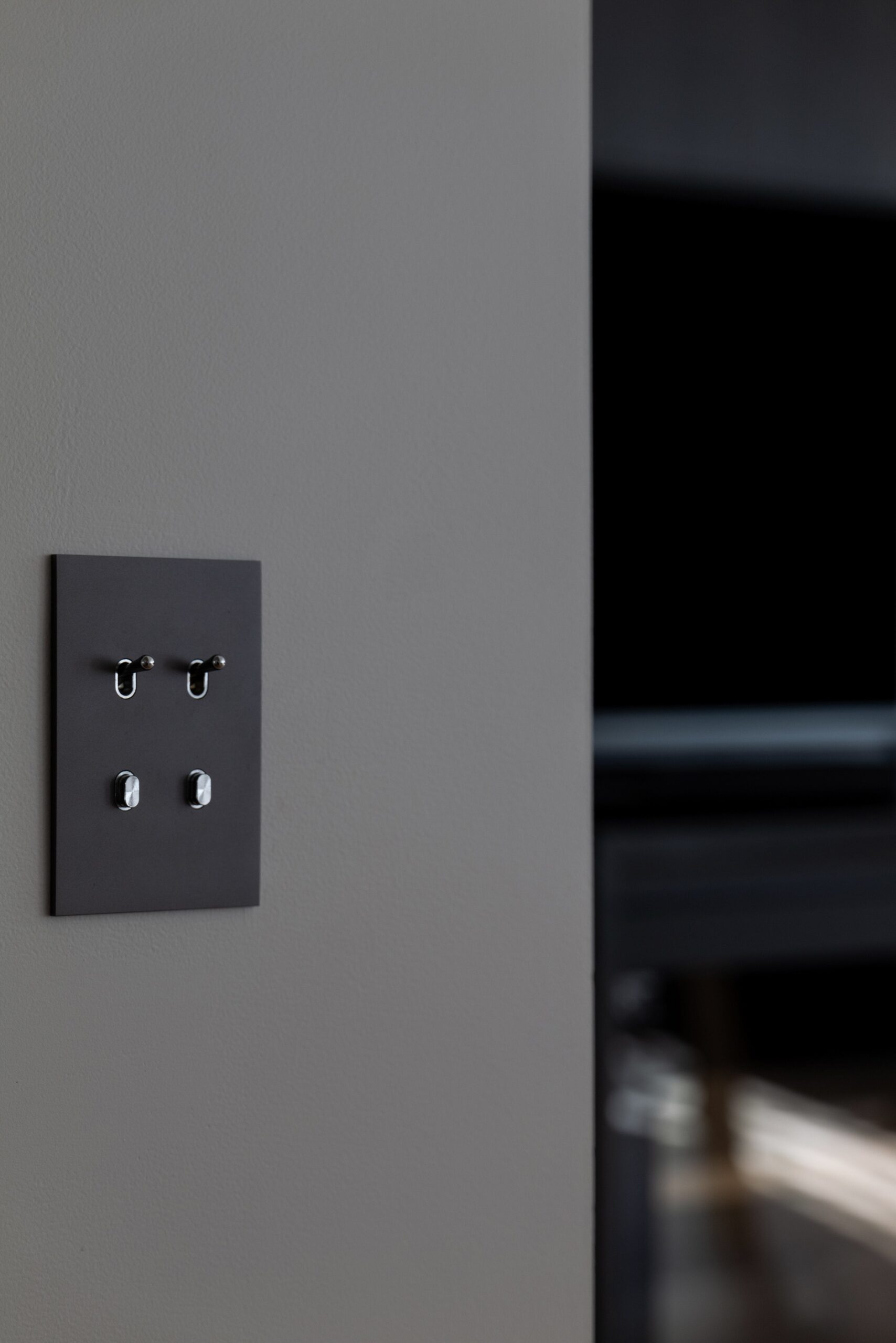 A light switch on a wall in a room.