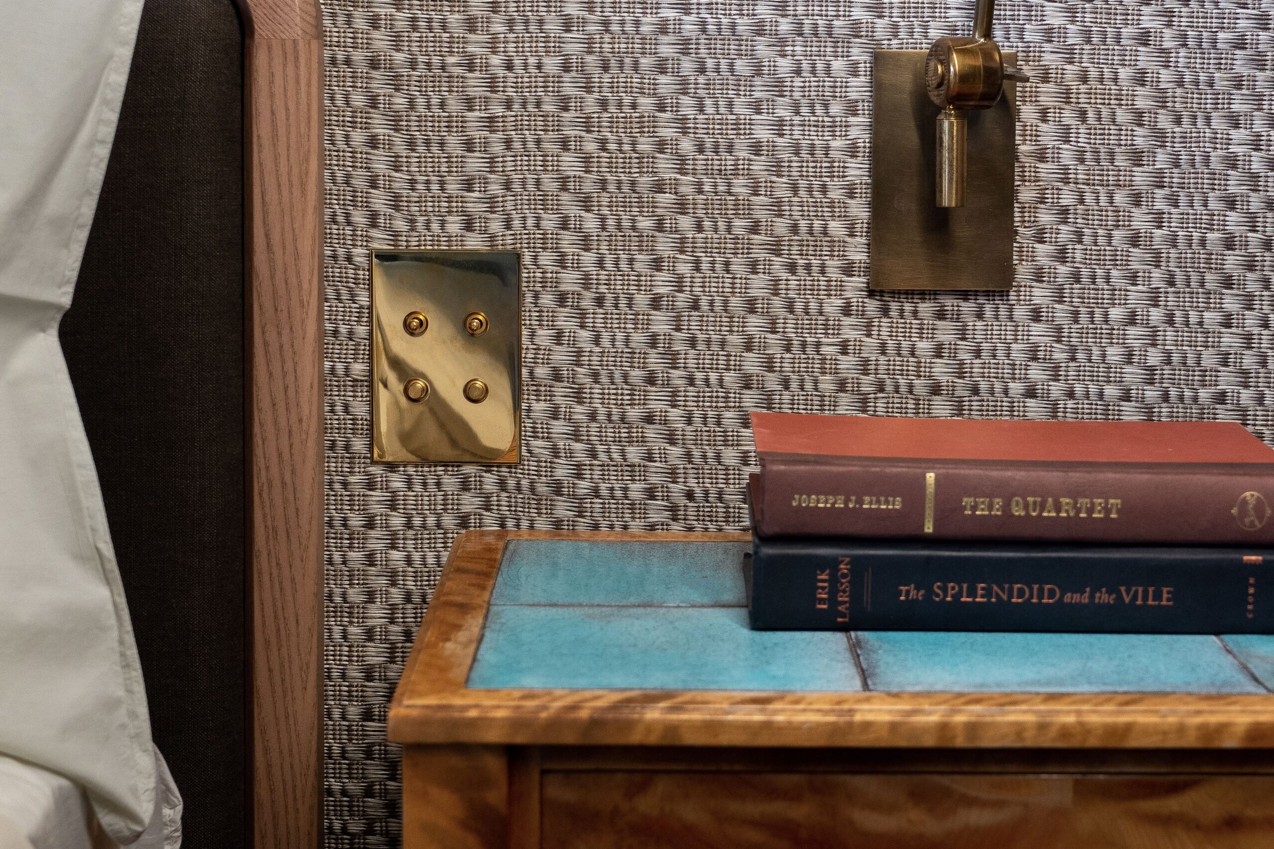 A bed with a book on top of it.