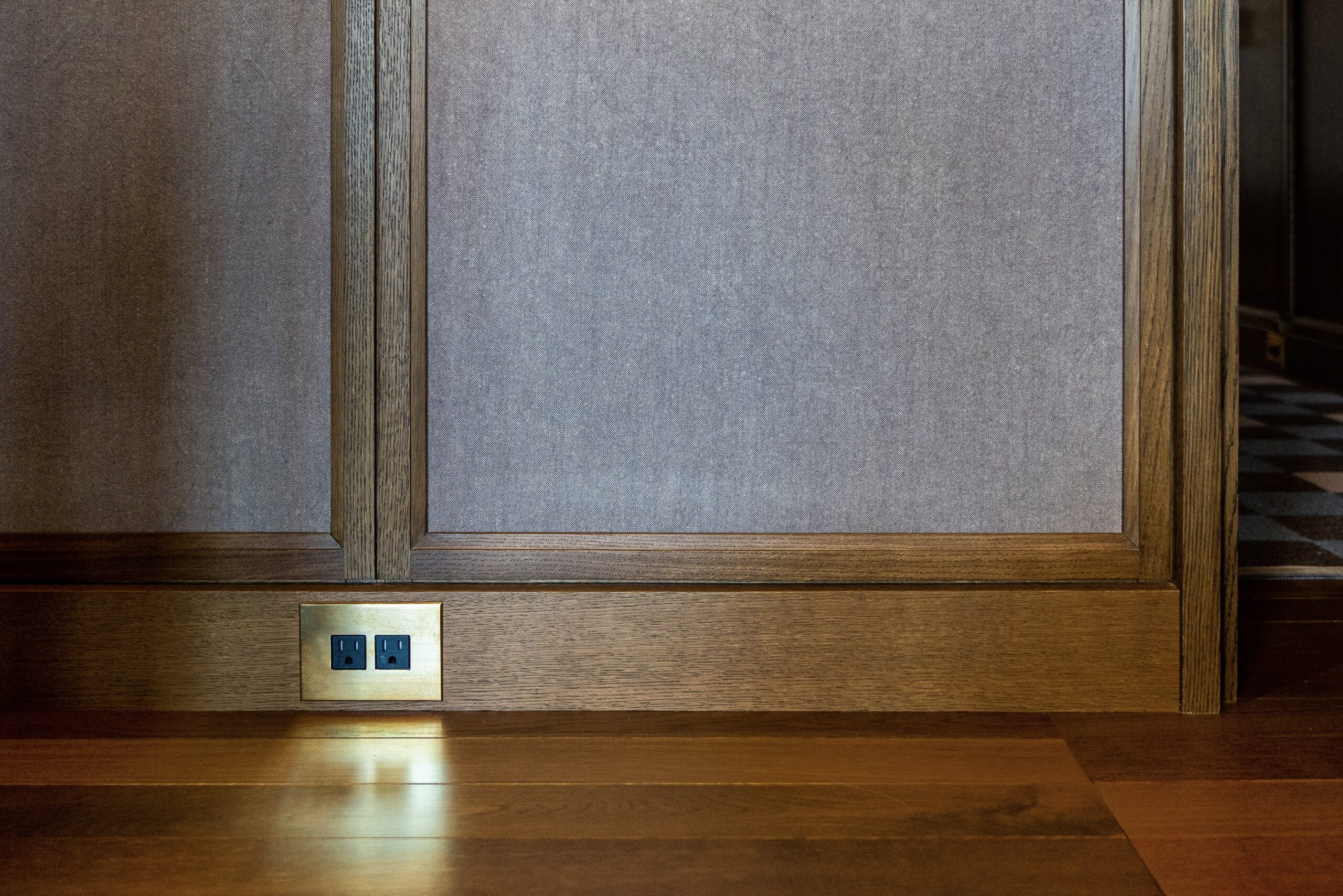A wooden floor in a room with a light on it.
