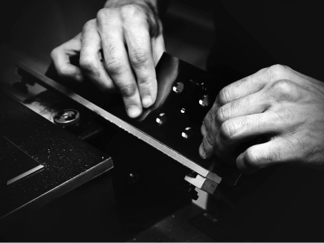Close-up of hands on a machine.