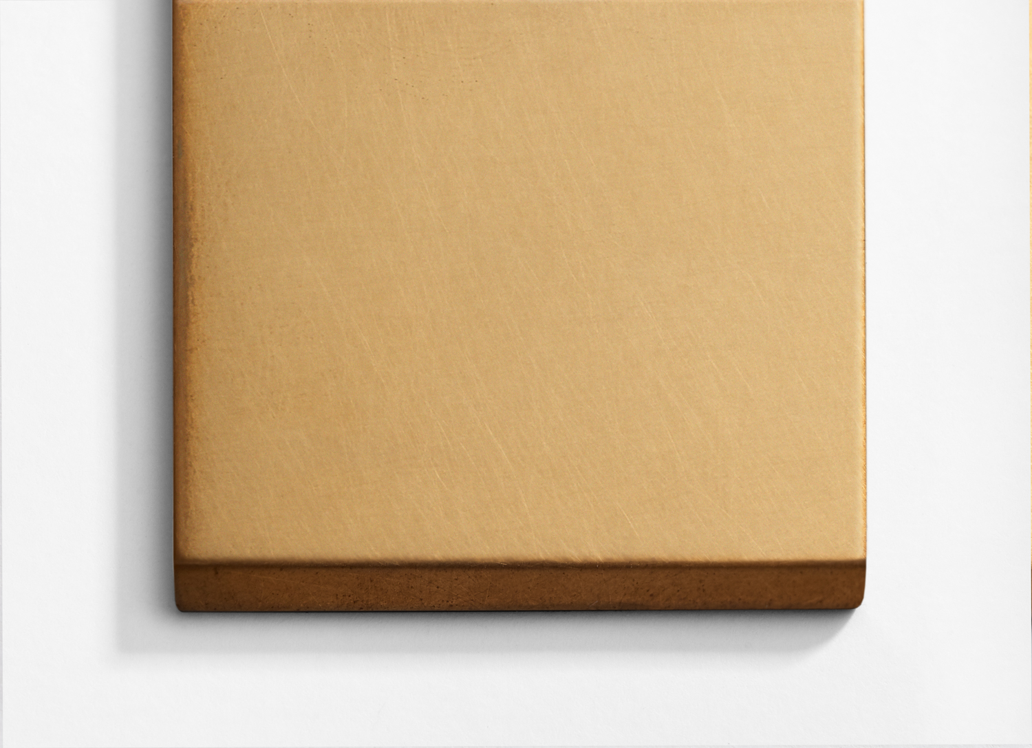 A gold square on a white wall.