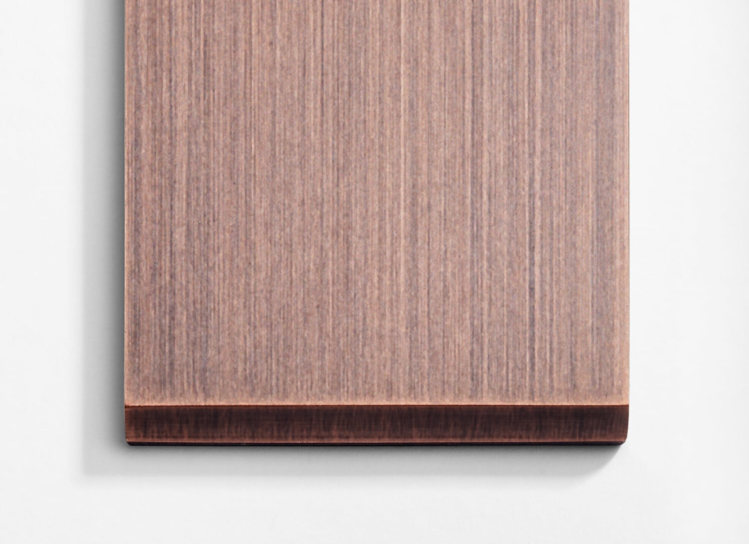 A piece of wood on a white surface.