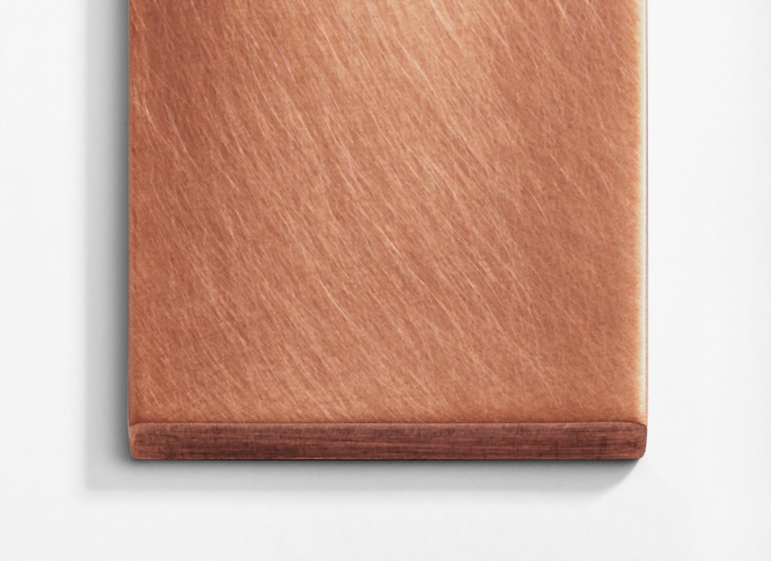 A copper plate on a white surface.