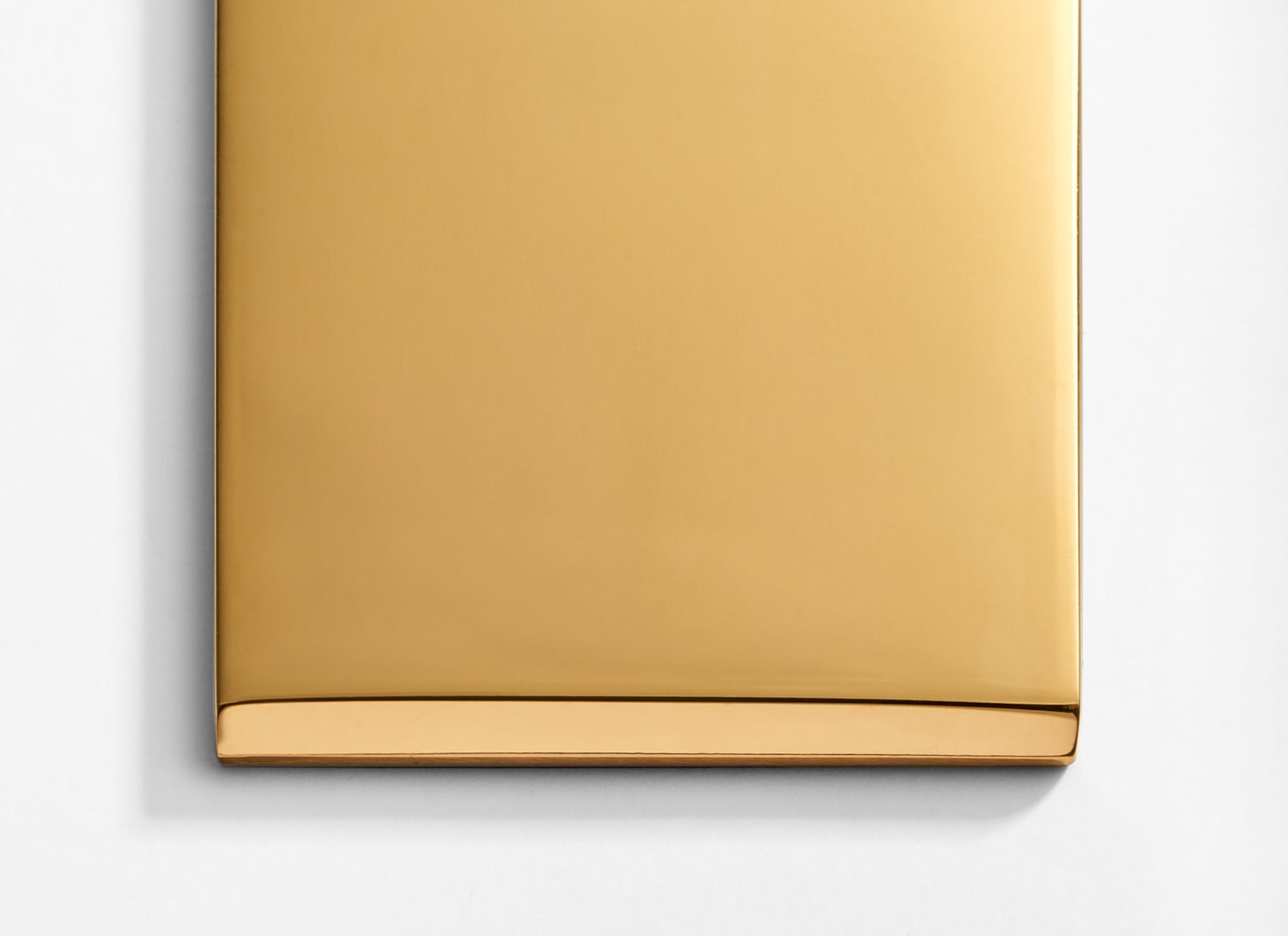 A gold plate on a white surface.